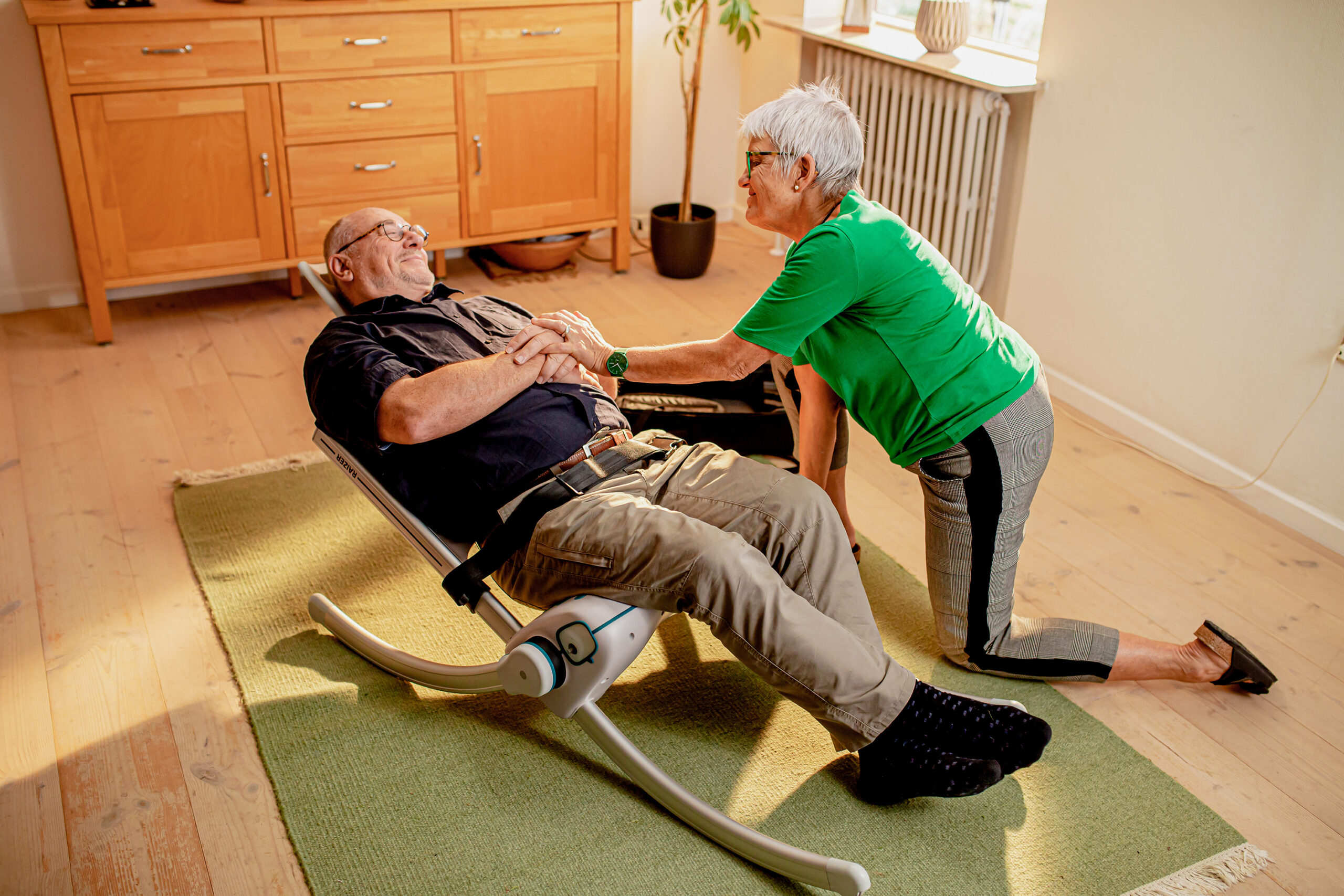 a woman using a Raizer-M to help lift a man