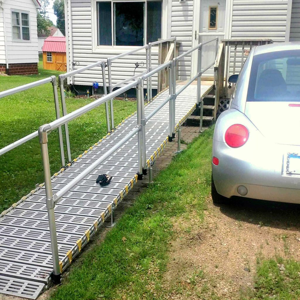 a Roll-A-Ramp set up over a porch with stairs