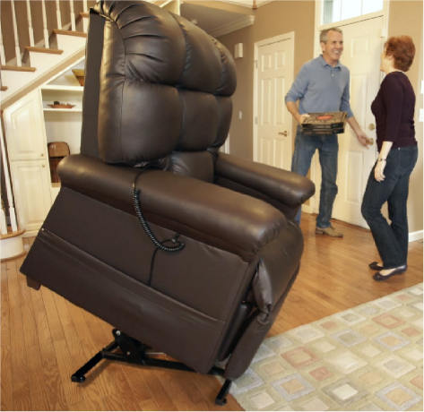 a man and woman talking in a room with a raised lift chair